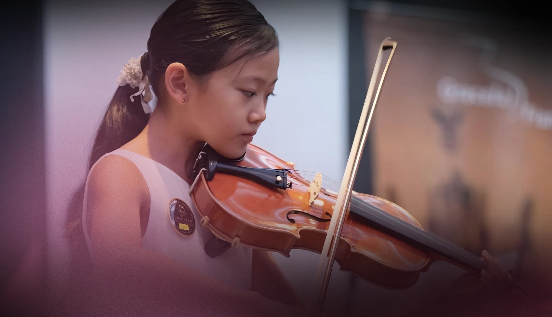 A young violinist performing at Gold Star Music Festival